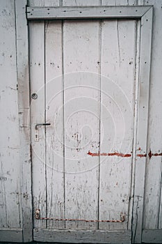 Old barn door white with signs of weathering