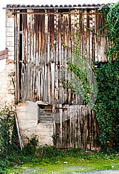 Old barn enclosed by old wooden boards.