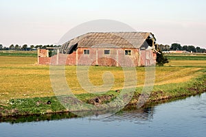 Old barn on a field.