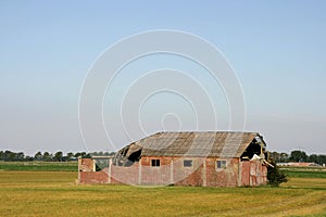 Old barn on a field.