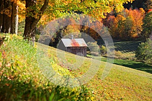 Old barn nestled in Vermont mountains