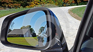 Old barn in rearview mirror