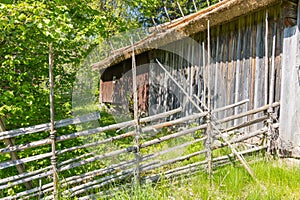 An old barn and roundpole fence