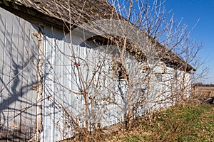 Old barn wall with newer white siding and original wood shingles