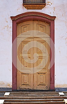 Old baroque church door in Serro, Minas Gerais, Brazil photo
