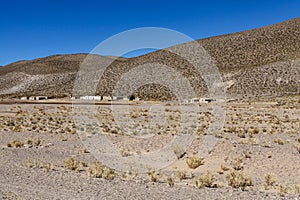 Old barracks and brown mountains near the Salinas Grandes, Salta North Argentina