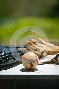 Old baseball ball, mitt and batting gloves, copy space