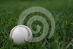 Old Baseball in the green grass