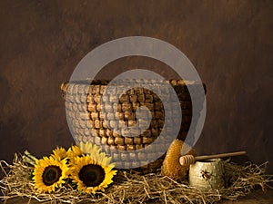 Old basket beehive and sunflowers