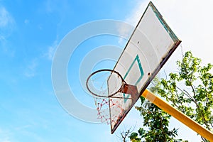 Old basketball backboard at outdoor street court.