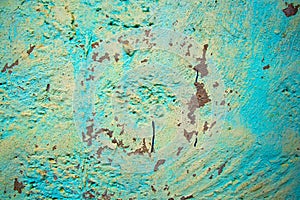 An old battered wall with colored plaster