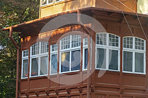 Old bay window balcony in wooden house. Selective focus, fog view