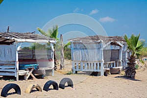 An old beach cafe with wooden houses painted white