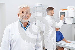 Old beard doctor and assistant working with ultrasound.