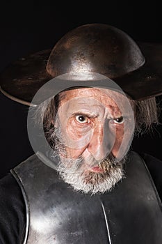 Old bearded man with breastplate and helmet