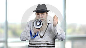 Old bearded man making encourage speech in megaphone.