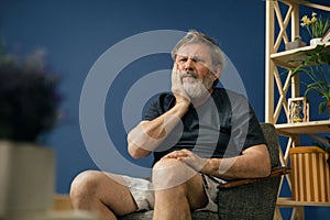 Old bearded man suffering from pain