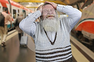 Old bearded man wearing casual sweater feeling stress and desperation.