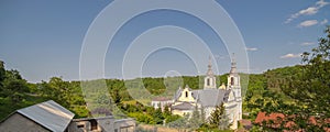 Old, beautiful church of Our Lady of Sorrows from the 18th century, among the green hills in Baltow.