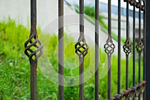 Old beautiful decorative metal wrought fence with artistic forging. Iron rusty guardrail need to be painting and repaired