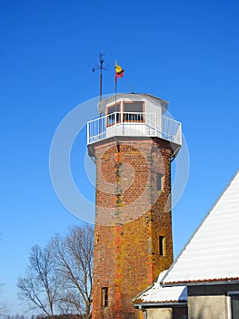 Old red bricks lighthouse near Atmata river, Lithuania