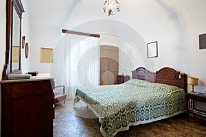Old bedroom with queen double bed in ancient house