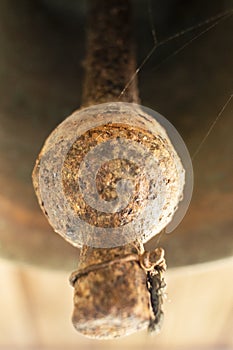 Old bell corroded by rust with the predominant brown color