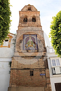 Old bell tower decorated with tiles with the image of the Virgin Mary of Ntra. Sra. de la Paz, in the town of Medina Sidonia photo