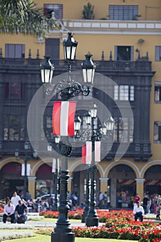 Old belvedere and flag from Peru on Plaza de Armas, Lima photo
