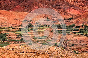 Old berber architecture in High Atlas Mountains region in Morocco. Houses of clay at the foot of the mountains.