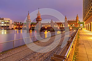 Old Berlin Oberbaum Bridge over the Spree River at sunset.