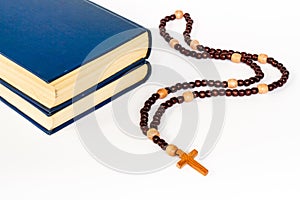 Old Bible book with wooden christian rosary beads