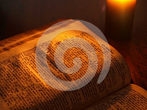 Old bible by candlelight photo