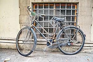 Old bicycle against a rustic wall