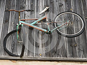 An old bicycle is bolted to the wall