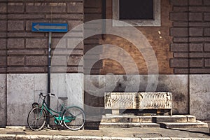 Old bicycle near an ancient Roman drinking fountain. Vintage atmosphere in the city center of Rome