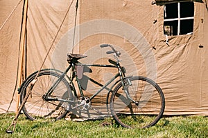 Old Bicycle Parked Next To Large Soviet Military Canvas Khaki Tent