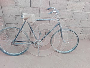 An old bicycle parked on the wall