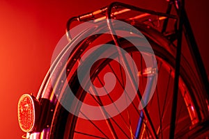 Old bicycle rear wheel with dynamo headlight isolated on color background. Vintage concept. Neon lights