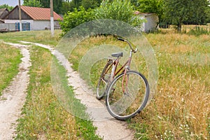 Old bicycle waiting for the master on the roadside