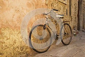 Old bicycle at a wall