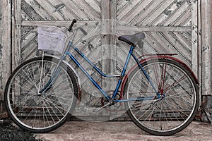 Old bicycle on wooden background