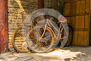 Old bikes in an empty narrow alley in a traditional Beijing Hutong in China - 1