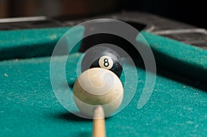 Old billiard ball 8 on a green table. billiard balls isolated on a green background