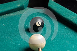 Old billiard ball 8 on a green table. billiard balls isolated on a green background