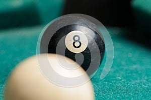 Old billiard ball 8 on a green table. billiard balls isolated on a green background