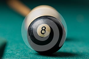 Old billiard ball 8 on a green table. billiard balls isolated on a green background