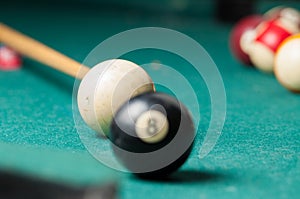 Old billiard ball 8 on a green table. billiard balls isolated on a green background