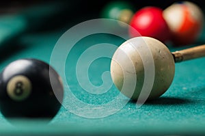 Old billiard ball 8 on a green table. billiard balls isolated on a green background