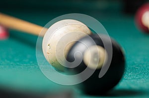 Old billiard ball 8 on a green table. billiard balls isolated on a green background